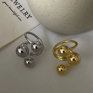 Three-layer brass gold-plated rings with polished metal spheres in gold and silver