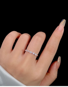 Close-up of s925 silver ring with marquise and round cubic zirconia on hand