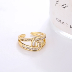 Golden double-layer knot ring with zircon stones in a minimalist luxury design