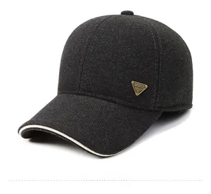 Detail of grey wool baseball cap showing the spirit metal badge and contrast piping