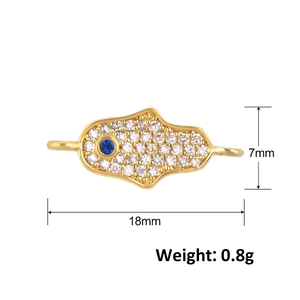 Detailed view of a gold Hamsa Hand charm with zircon, measuring 18mm by 7mm and 0.8g