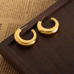 Minimalist C-shaped gold-plated titanium earrings with a polished mirror finish surface