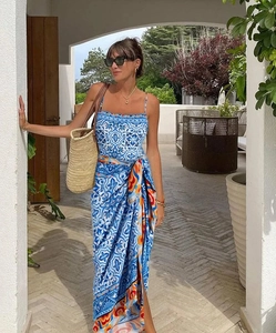 Detail of blue and white tile print maxi dress with waist tie and side slit detail