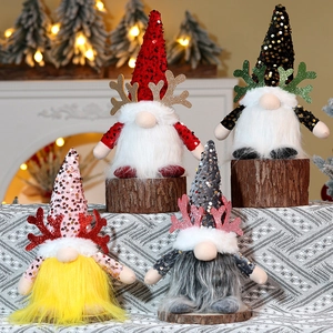 Group of festive Christmas gnomes with reindeer antlers and sequins by a fireplace