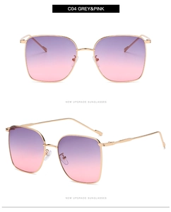 Detail view of square metal sunglasses with gold frame and purple-pink gradient lenses