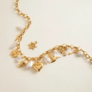 18K gold plated stainless steel charm bracelet featuring baroque pearls and nature motifs