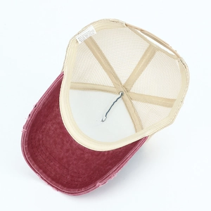 Detail view of burgundy distressed baseball cap with breathable mesh and cotton fabric