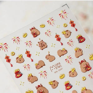Macro shot of 3D embossed Capybara nail stickers with gold ingots and red lanterns