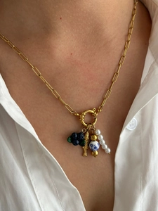 Detailed shot of a 18K gold-plated chain with blueberry charms and pearl drop necklace