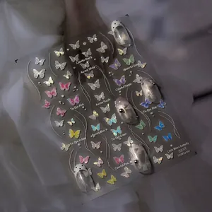 Detail of white butterfly nail stickers with pearlescent shell luster effect