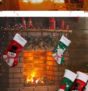 Detail of plush Christmas stockings with snowman and reindeer hanging by a cozy fireplace