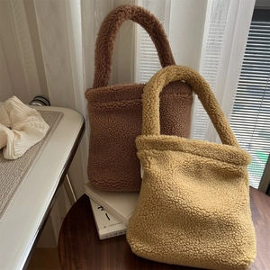 Winter faux fur handbag in warm brown and cream white lamb wool plush textures