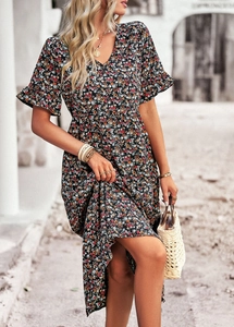 Detail of floral V-neck dress featuring ruffled short sleeves and waist-cinching design