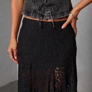 Chic black sheer lace maxi skirt with hollow out pattern and elegant lining for summer fashion