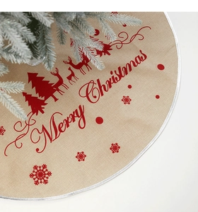 Detail of linen Christmas tree skirt featuring reindeer patterns and Merry Christmas text