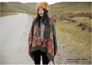 Detail of army green ethnic shawl with vintage floral patterns and black tassels