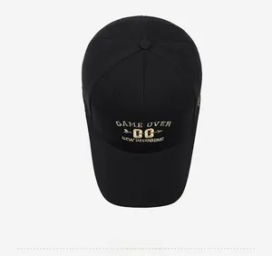 Top view of black canvas baseball cap showing detailed golden embroidery texture