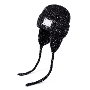 Winter chunky knit beanie with earflaps, black speckled yarn and logo patch detail