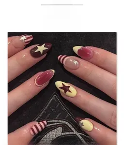 Detailed view of almond-shaped press-on nails with burgundy, cream stripes and stars