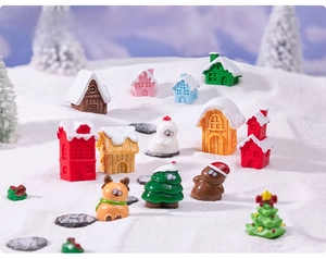 Miniature Christmas house set with reindeer and snow-covered trees for holiday DIY decor