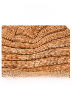 Detailed macro texture of thick wavy knitted winter beanie in orange warmth wool fabric