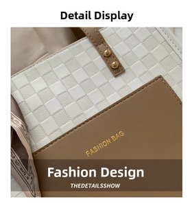 Detail of white checkered embossed leather bag with brown trim and gold rivets