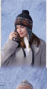 Detail of gray winter knit hat featuring colorful stripes and plush earflaps with long ties