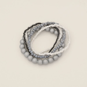 Detail view of multi-layer bohemian bead bracelet set with silver and grey beads