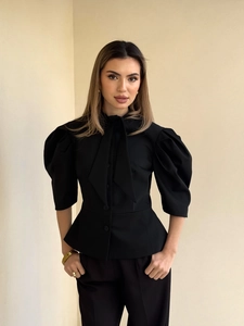 Slim fit black button-up top with puff sleeves and lace-up neck for a chic vintage look
