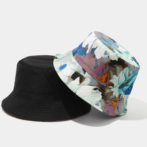 Reversible bucket hat for women with floral print and solid black cotton fabric for sun protection