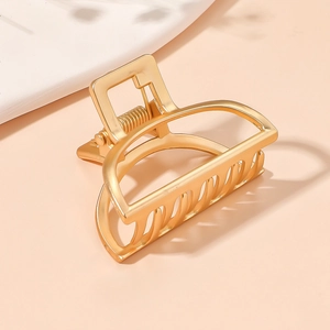 Elegant gold metal hair claw clip with hollow geometric design for high ponytail styling