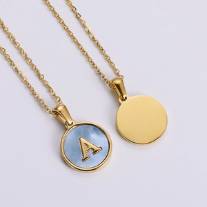 Macro view of 18k gold plated stainless steel necklace with blue shell pendant and letter A