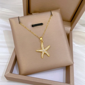 Elegant gold starfish pendant necklace with pavé cubic zirconia on a luxury chain