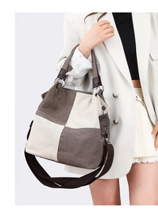 Detail of color-block canvas tote bag with adjustable strap and textured hardware