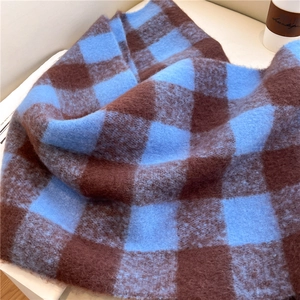 Detail of brown and blue checkered scarf showing soft plush cashmere-like texture