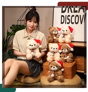Detailed view of plush Christmas teddy bears in beige and brown colors with holiday scarves