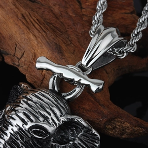 Detailed macro view of a silver elephant head pendant on a thick twisted rope chain