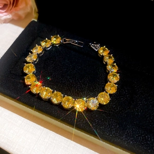 Macro view of adjustable yellow zircon tennis bracelet in a black velvet jewelry box
