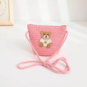Detailed view of kids pink straw crossbody bag with cute teddy bear embroidery patch