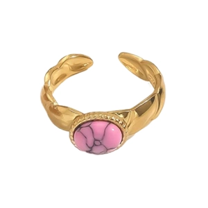 Detailed close-up of 18K gold wave band ring with oval pink natural stone inlay