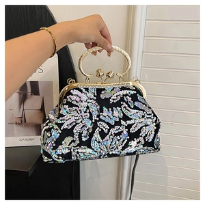 Detail of vintage sequin shell bag with gold metal handle and diamond-encrusted buckle