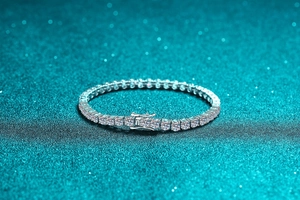 Macro shot of silver 925 tennis bracelet featuring round cut moissanite in four-prong settings