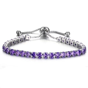 Macro detail of purple round-cut crystal tennis bracelet with adjustable slider clasp