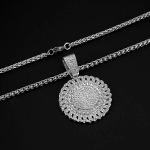 Detail of silver hip hop necklace with iced-out diamond circular pendant and twist chain