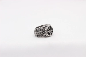 Macro shot of Viking compass Vegvisir symbol and Norse runes on vintage steel ring