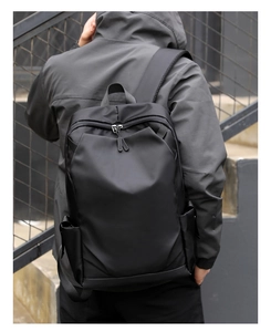 Rear view of a black business laptop backpack on a model with minimalist design