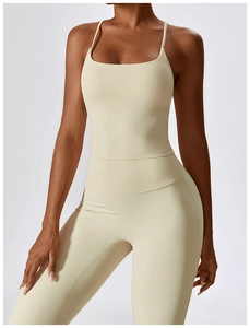 Detail view of beige yoga bodysuit featuring thin straps and slimming waist seam lines