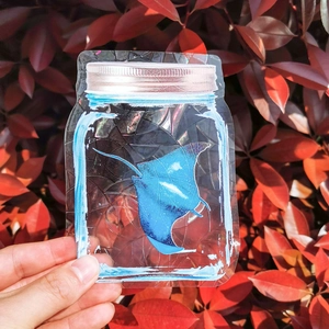 Holographic suncatcher window sticker featuring a blue manta ray inside a glass jar