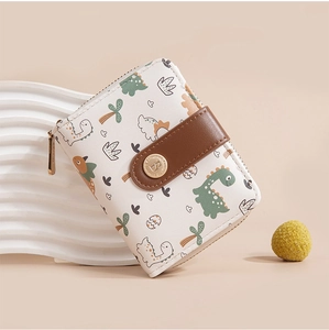Detail of cream short wallet with green dinosaur print and gold zipper by Baellerry