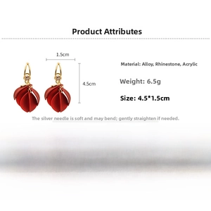 Detailed view of red acrylic petal earrings with gold alloy studs and sparkling rhinestones
